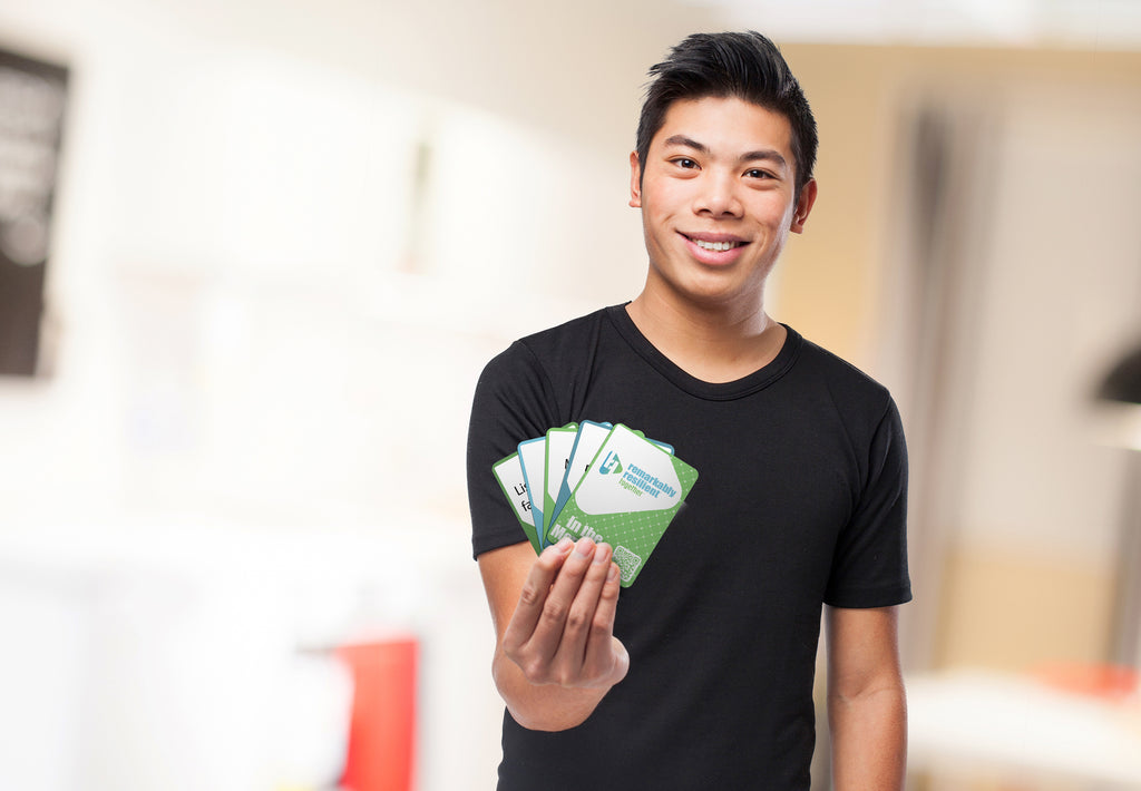 A man holding a fanned-out set of RRT cards